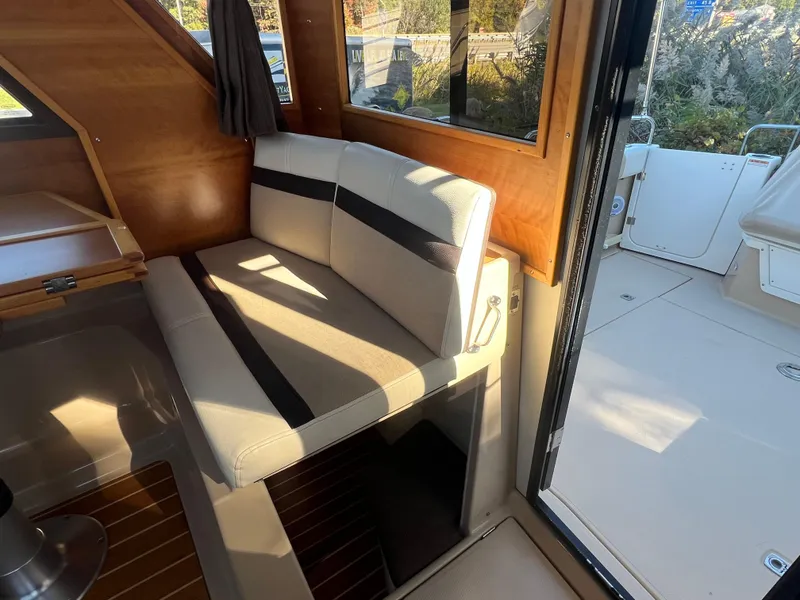 Slide: The Image of Interior of 2016 Cutwater C28 boat with beige seating and wooden accents. - 28