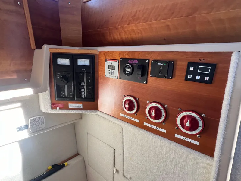 Slide: The Image of Electrical control panel on a 2016 Cutwater C28 boat, featuring switches and gauges. - 29