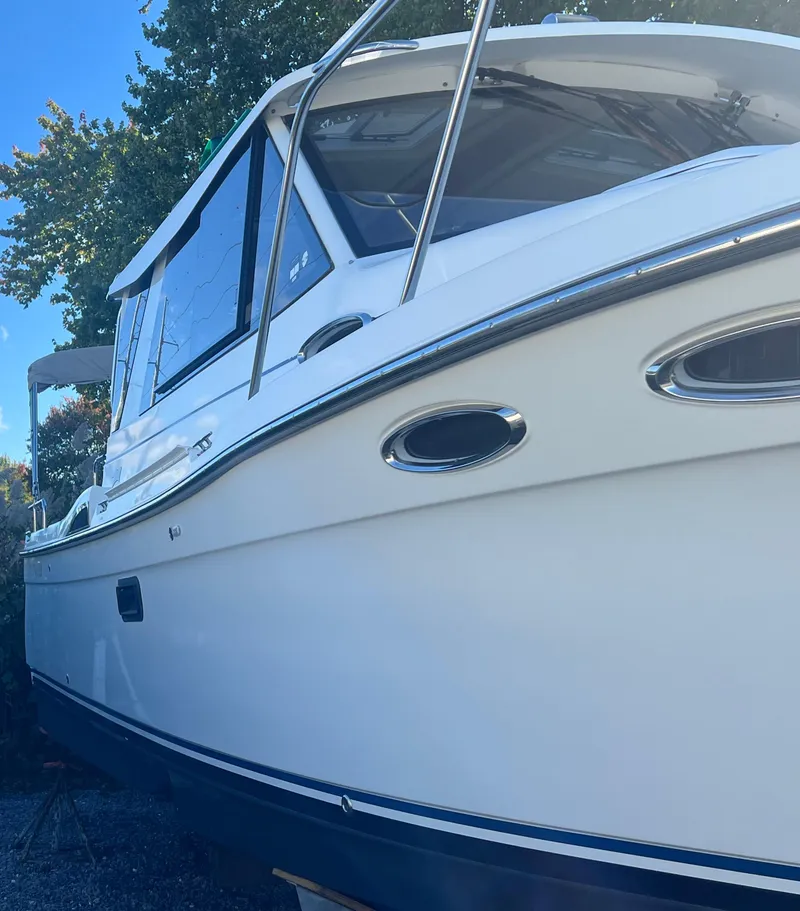 Slide: The Image of 2016 Cutwater C28 boat, white exterior, docked outdoors, side view. - 3