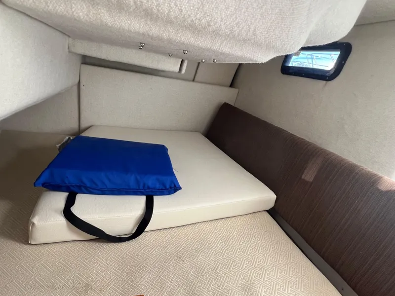 Slide: The Image of Interior cabin of a 2016 Cutwater C28 boat with a blue cushion. - 30