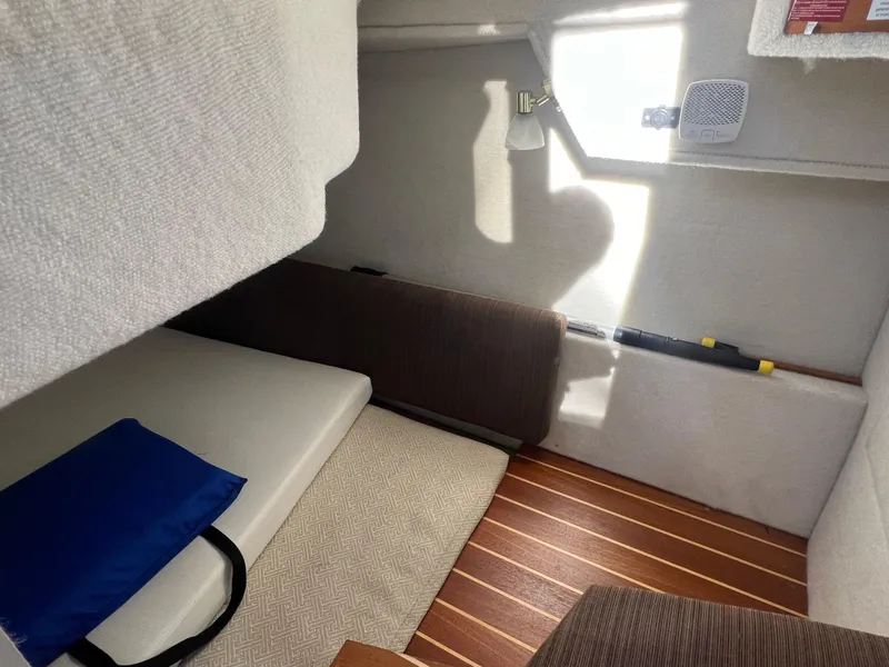 Slide: The Image of Cozy interior cabin of 2016 Cutwater C28 boat with seating and wooden flooring. - 31