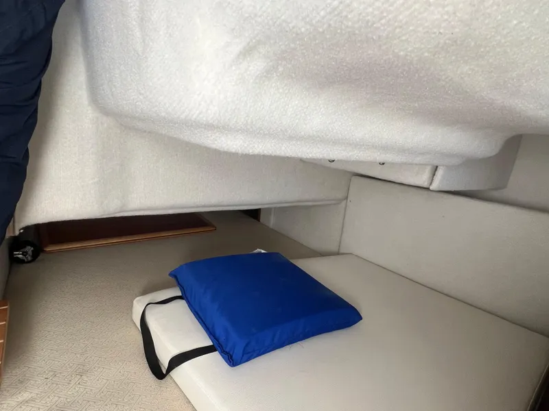 Slide: The Image of Interior cabin of a 2016 Cutwater C28 boat with a blue cushion. - 32