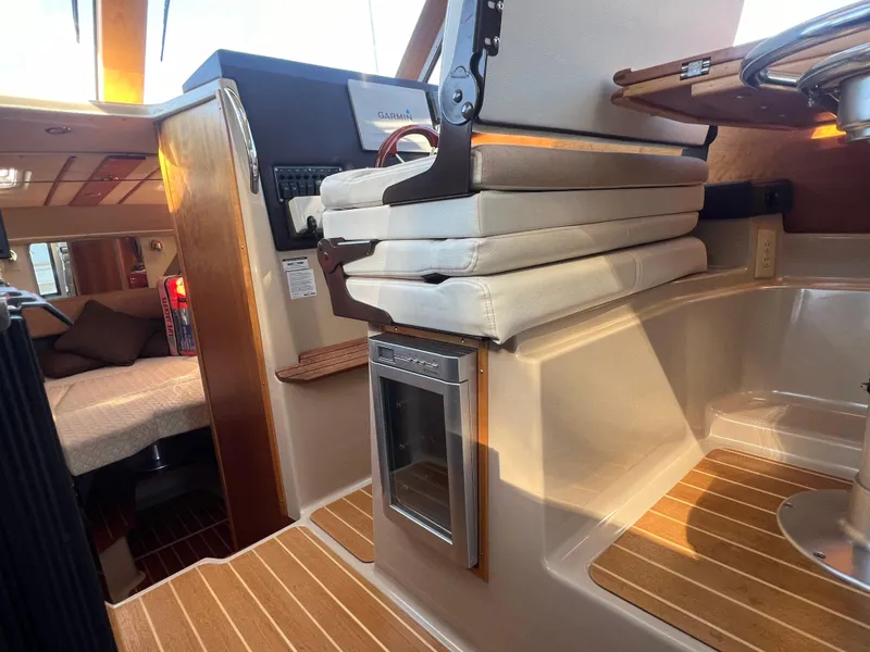 Slide: The Image of Interior of 2016 Cutwater C28 boat with cushions and wood accents. - 35
