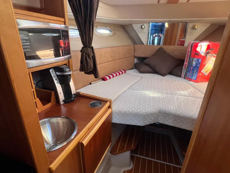 Slide: The Image of 2016 Cutwater C28 cabin interior with bed, microwave, coffee maker, and sink. - 39