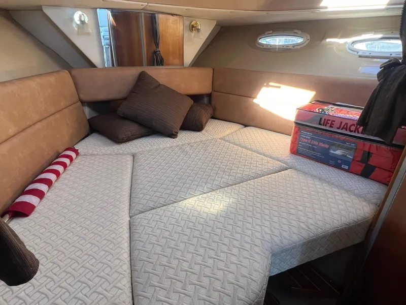 Slide: The Image of Interior of 2016 Cutwater C28 boat with cozy bed, pillows, and life jackets. - 41