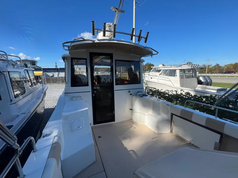 Slide: The Image of 2016 Cutwater C28 boat with spacious deck and seating, docked under clear blue sky. - 6