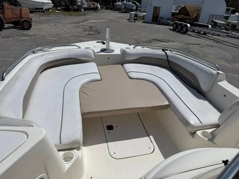 Slide: The Image of 2002 Hurricane FunDeck 211 O/B boat with spacious seating and beige cushions. - 13