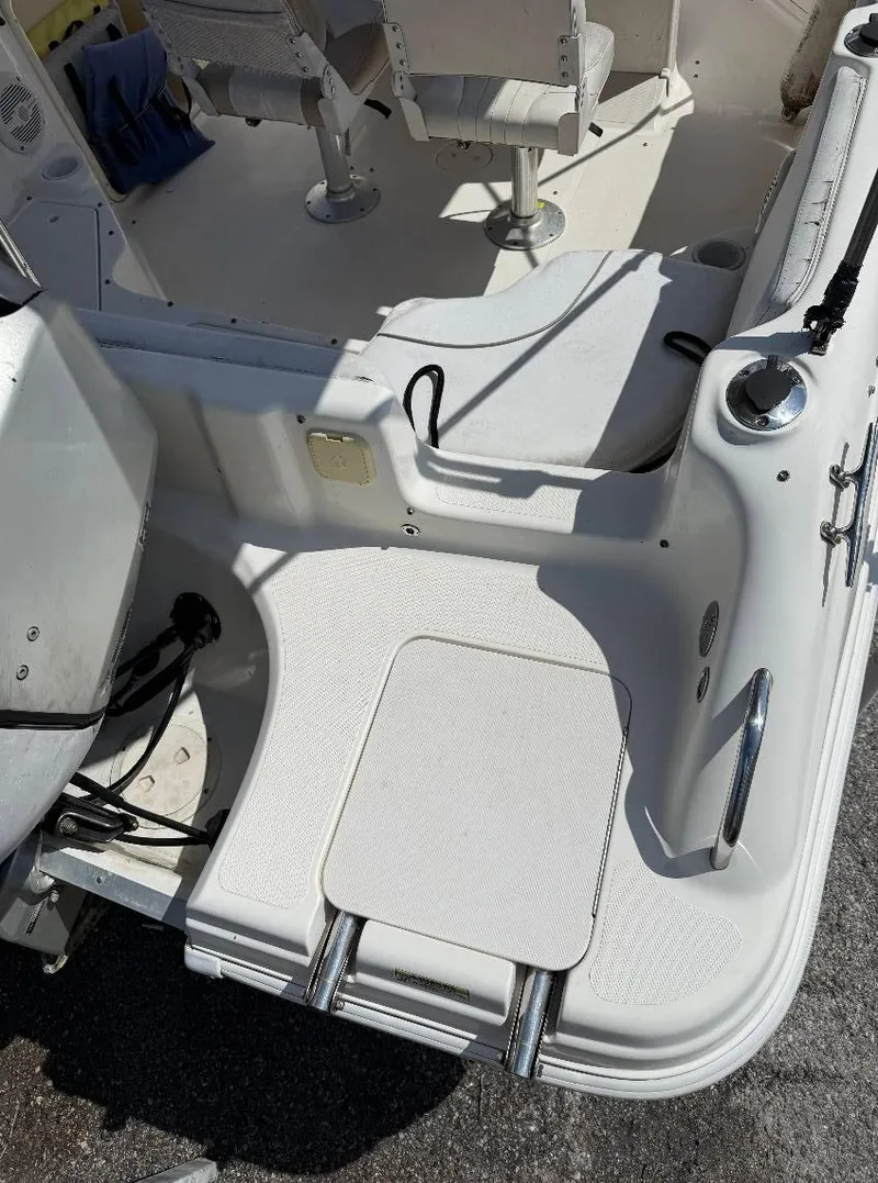 Slide: The Image of 2002 Hurricane FunDeck 211 O/B boat interior with seating and ladder. - 15