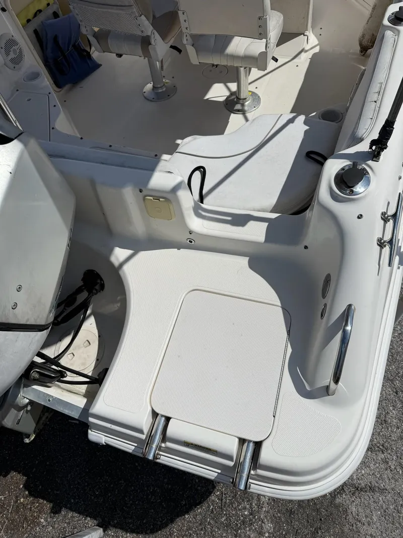 Slide: The Image of 2002 Hurricane FunDeck 211 O/B boat interior with seating and ladder. - 17