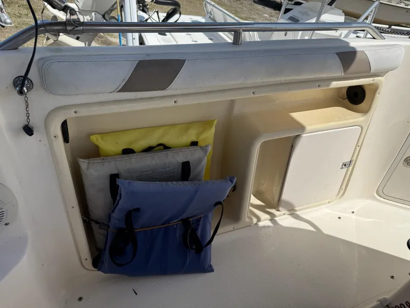 Slide: The Image of 2002 Hurricane FunDeck 211 O/B boat storage area with cushions and compartments. - 18