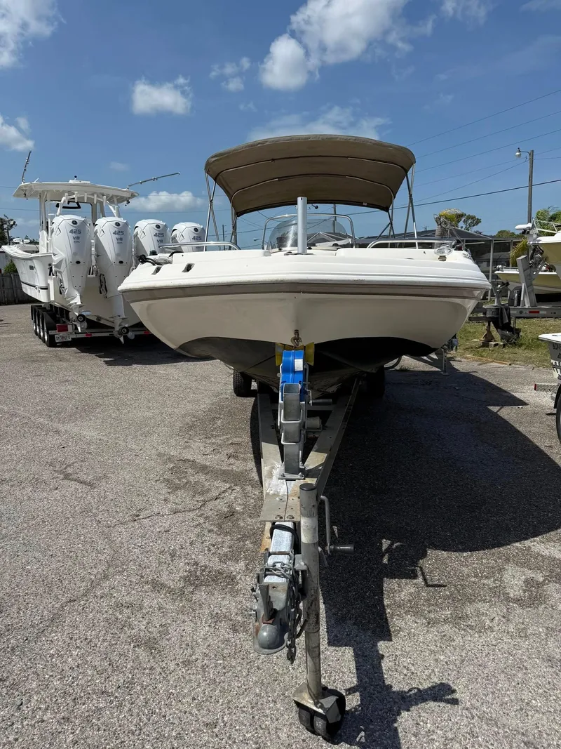 Slide: The Image of 2002 Hurricane FunDeck 211 O/B boat on trailer under clear sky. - 22