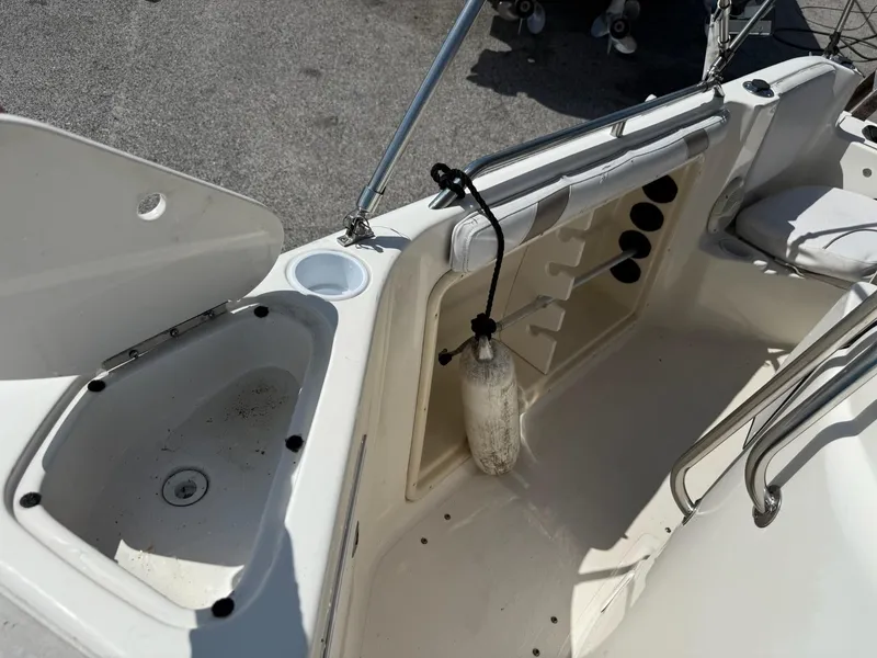 Slide: The Image of 2002 Hurricane FunDeck 211 O/B boat interior with storage compartments and seating area. - 26