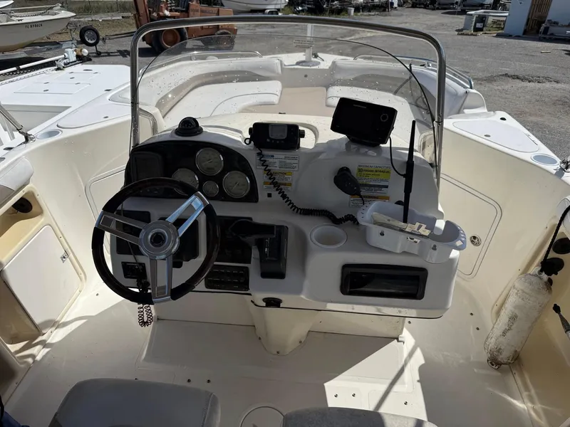 Slide: The Image of 2002 Hurricane FunDeck 211 O/B boat cockpit with steering wheel and control panel. - 27