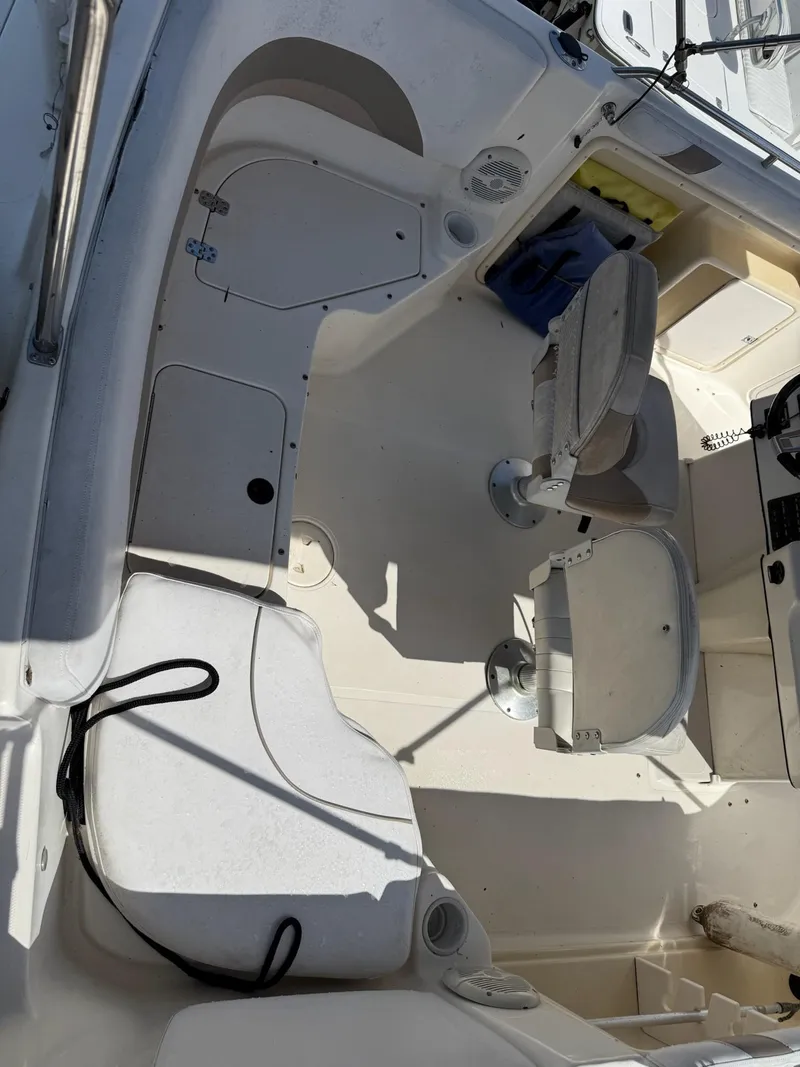 Slide: The Image of 2002 Hurricane FunDeck 211 O/B boat interior with seating and storage compartments. - 28