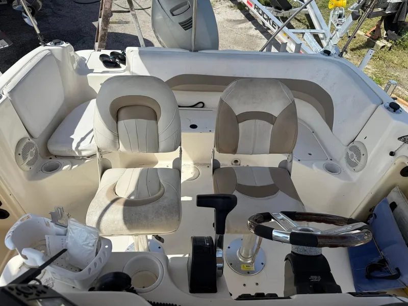 Slide: The Image of 2002 Hurricane FunDeck 211 O/B boat interior with dual seats and steering wheel. - 7