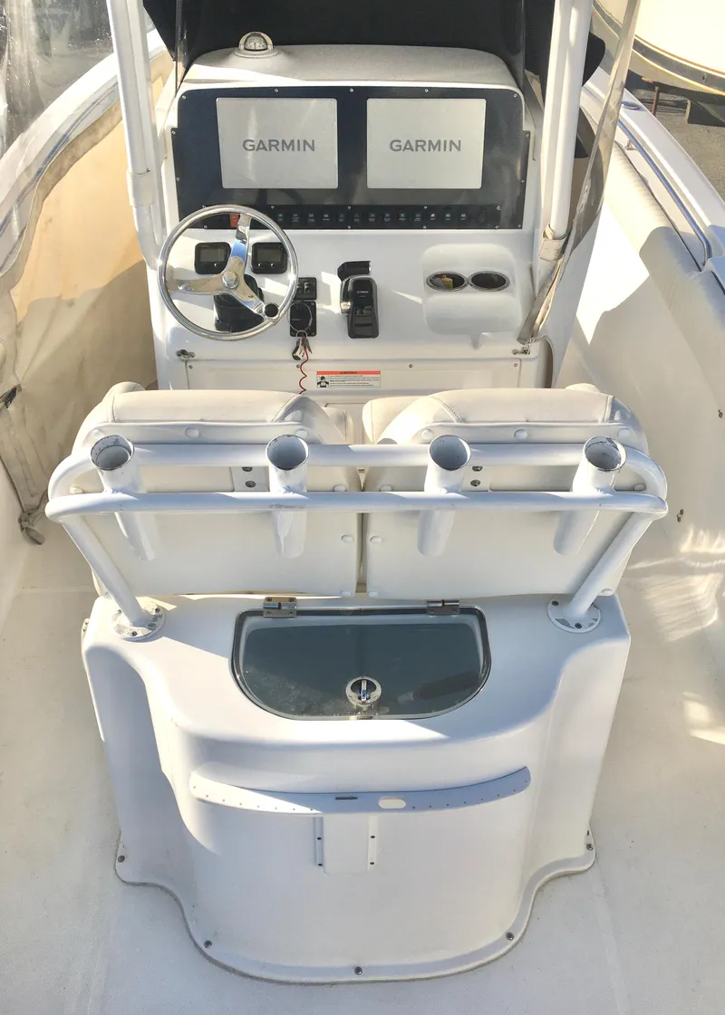 Slide: The Image of 2014 Sea Hunt Gamefish 25 boat cockpit with Garmin electronics and steering wheel. - 12