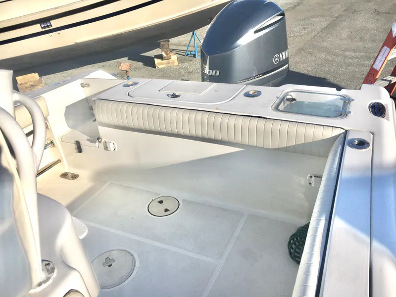 Slide: The Image of 2014 Sea Hunt Gamefish 25 boat interior with Yamaha engine, featuring spacious deck and seating. - 13