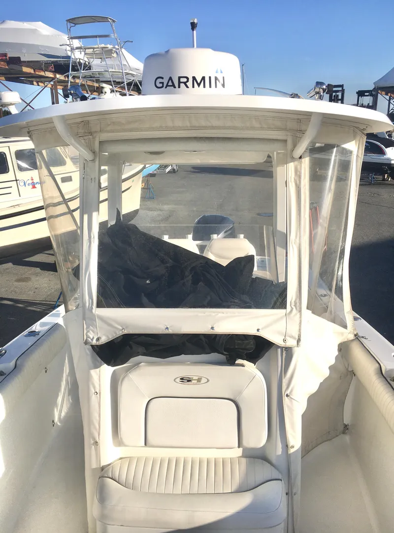 Slide: The Image of 2014 Sea Hunt Gamefish 25 boat with Garmin equipment, docked in a marina. - 14