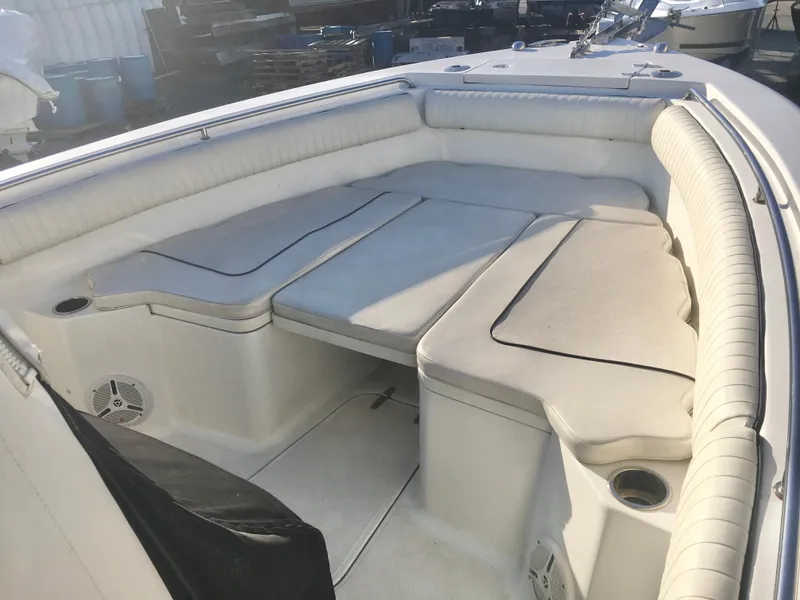 Slide: The Image of 2014 Sea Hunt Gamefish 25 boat interior with cushioned seating and cup holders. - 16