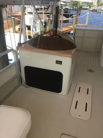 Slide: The Image of 1997 Sylvan Deck Boat interior with seating and water view. - 8