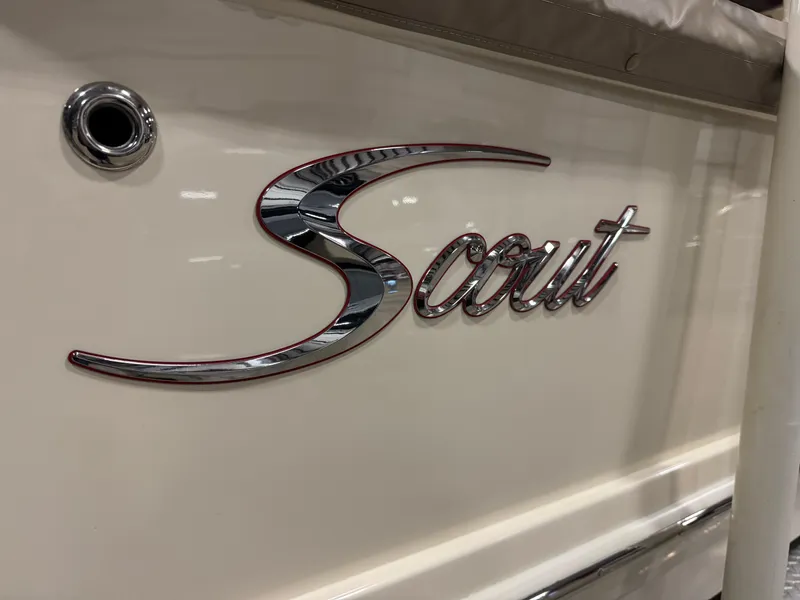 Slide: The Image of 2016 Scout 255 LXF boat logo on cream-colored hull. - 17