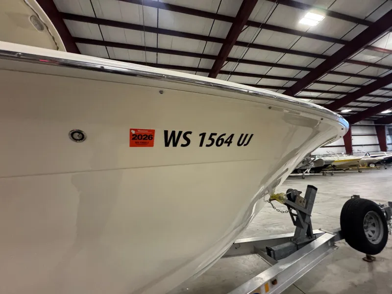 Slide: The Image of 2016 Scout 255 LXF boat on trailer in indoor storage facility. - 19