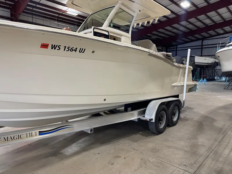 Slide: The Image of 2016 Scout 255 LXF boat on trailer in indoor storage facility. - 21