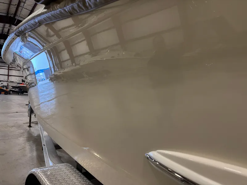 Slide: The Image of 2016 Scout 255 LXF boat in a warehouse, side view on trailer. - 22