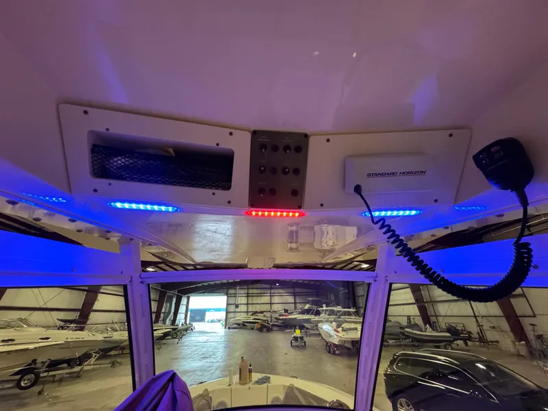 Slide: The Image of Interior view of a 2016 Scout 255 LXF boat with blue and red LED lights. - 29