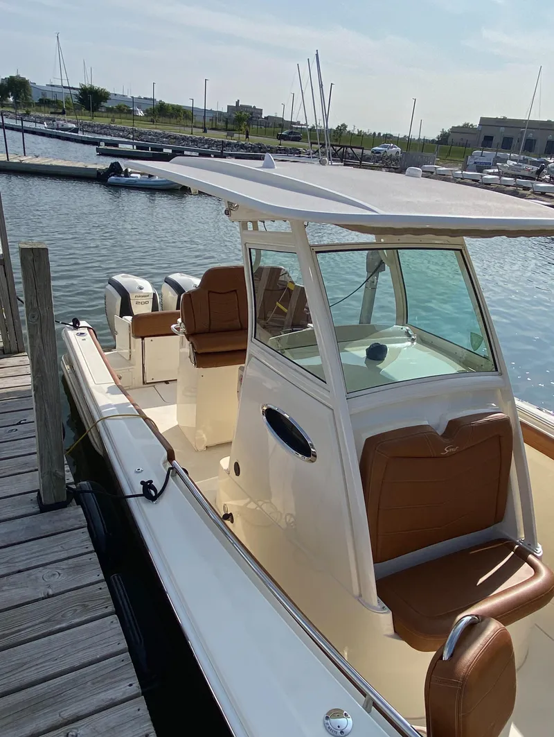 Slide: The Image of 2016 Scout 255 LXF boat docked at marina, featuring sleek design and modern amenities. - 3