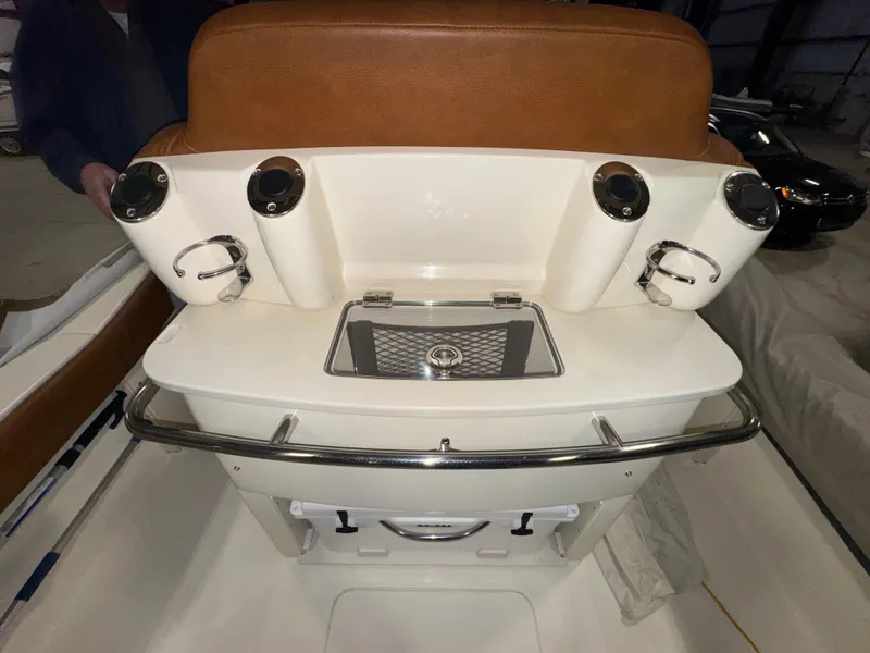 Slide: The Image of 2016 Scout 255 LXF boat interior with rod holders and storage compartment. - 35