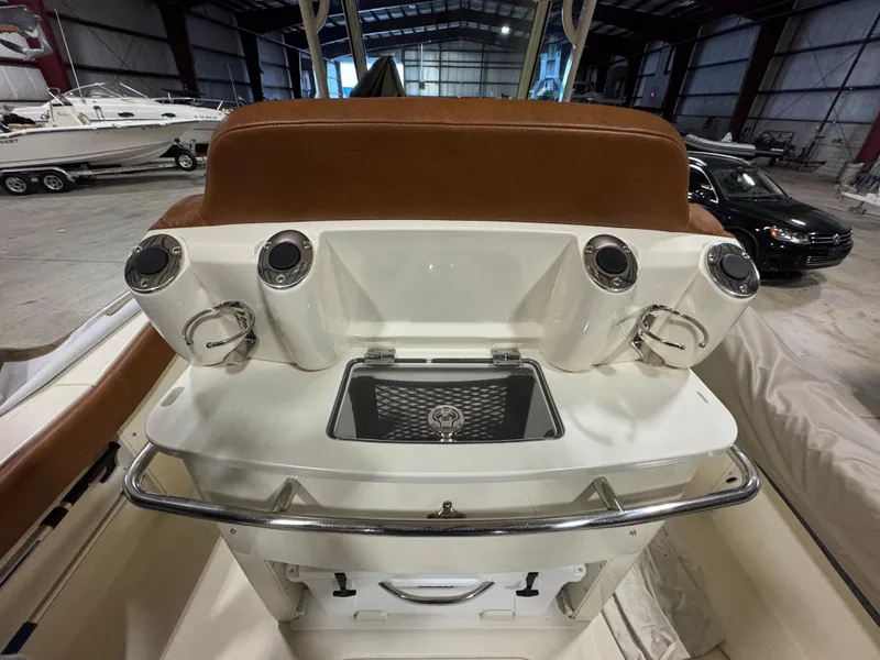 Slide: The Image of 2016 Scout 255 LXF boat interior with rod holders and storage compartment. - 36