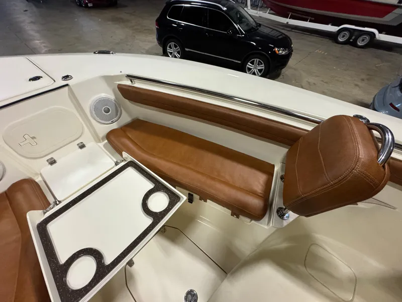 Slide: The Image of 2016 Scout 255 LXF boat interior with brown leather seating and table. - 39