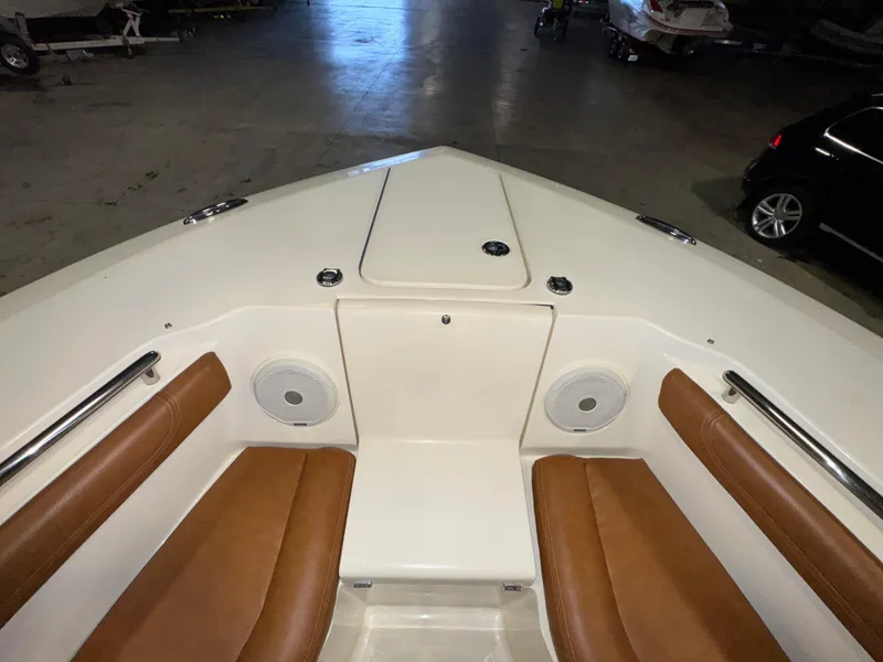 Slide: The Image of 2016 Scout 255 LXF boat interior with brown seating and speakers. - 43