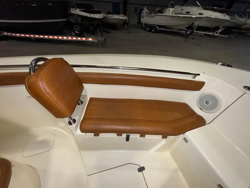 Slide: The Image of 2016 Scout 255 LXF boat interior with brown leather seating and speaker. - 44