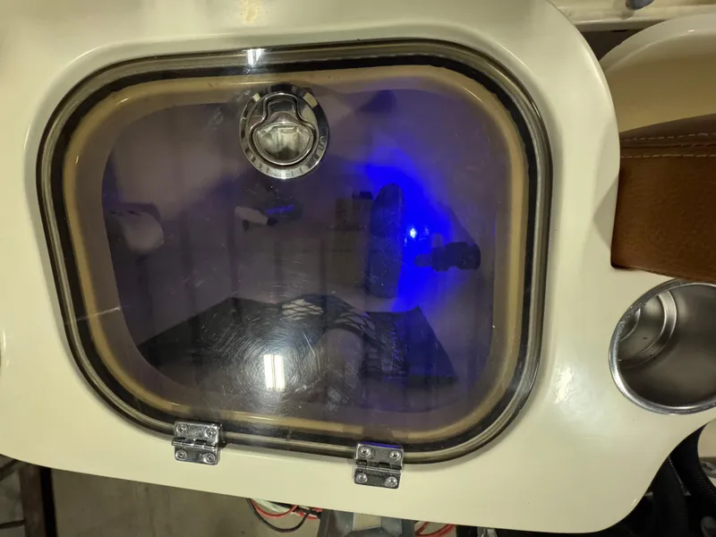 Slide: The Image of 2016 Scout 255 LXF boat compartment with blue interior lighting. - 49