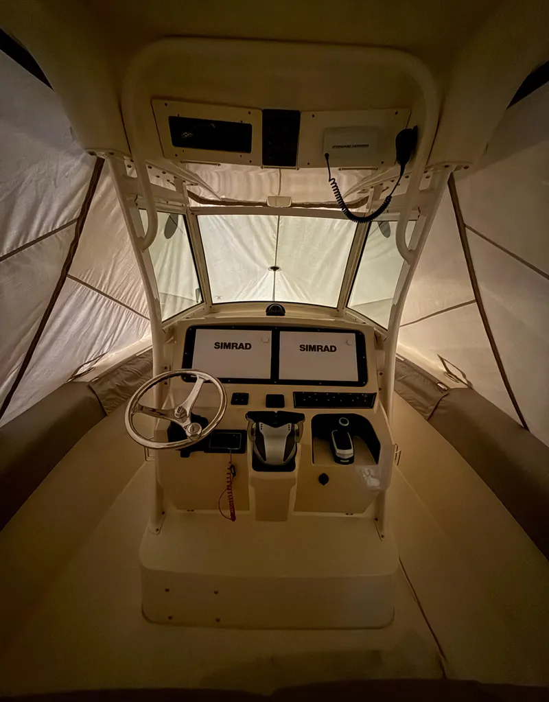 Slide: The Image of 2016 Scout 255 LXF boat interior with dual Simrad displays and steering wheel. - 8