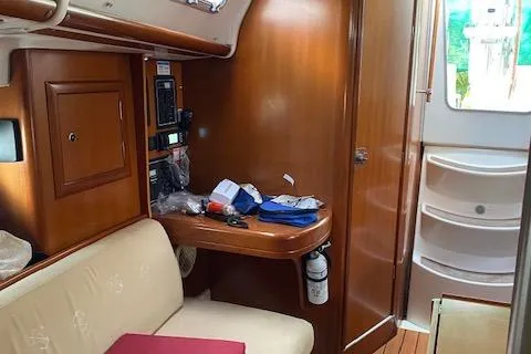 Slide: The Image of Interior of 2006 Beneteau Oceanis Clipper 323 sailboat with wooden cabinetry and seating. - 11