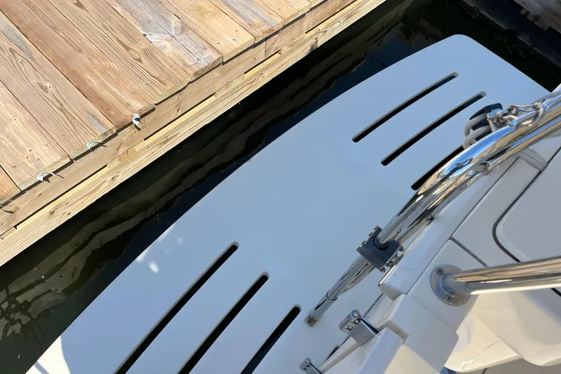 Slide: The Image of 2005 Mainship 400 Trawler docked, showing swim platform and wooden pier. - 10