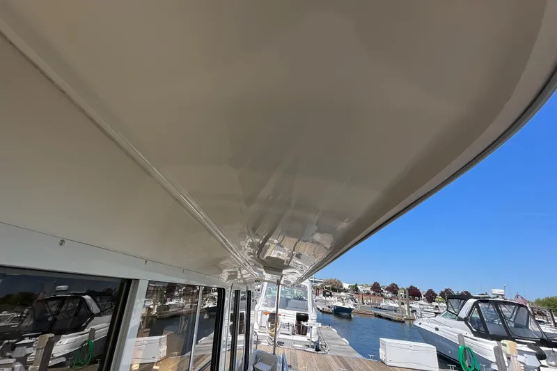 Slide: The Image of 2005 Mainship 400 Trawler docked at marina, view of deck and surrounding boats. - 16