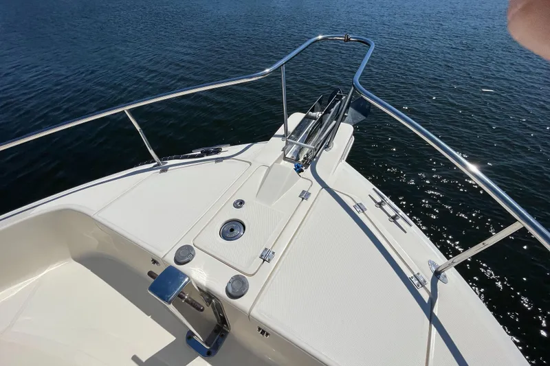 Slide: The Image of 2005 Mainship 400 Trawler bow with stainless steel railings on calm water. - 20