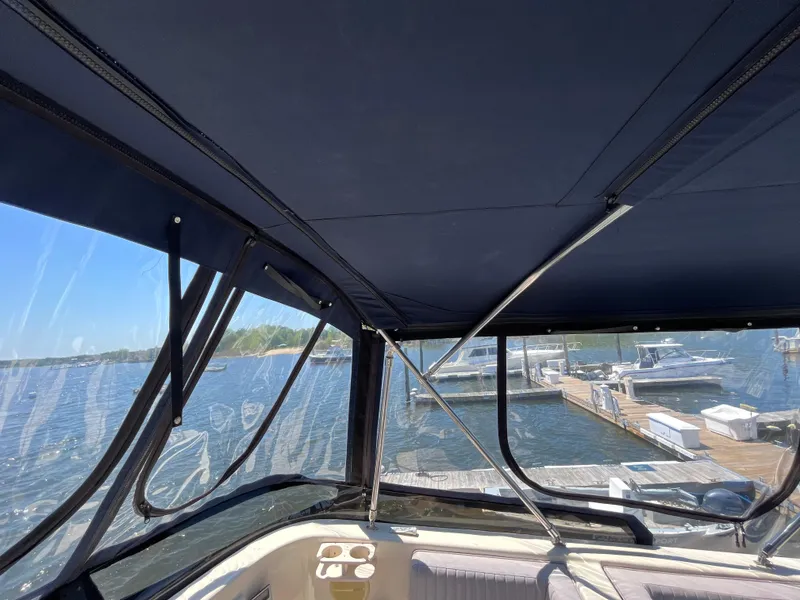 Slide: The Image of 2005 Mainship 400 Trawler interior view with marina backdrop. - 28