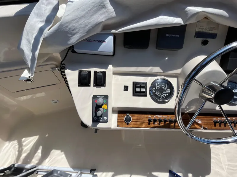 Slide: The Image of 2005 Mainship 400 Trawler helm with steering wheel and control panel. - 29