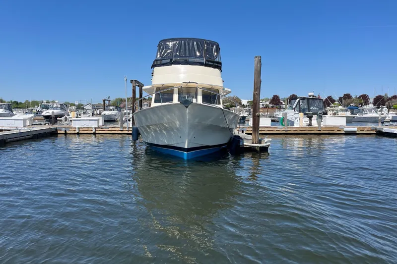 Slide: The Image of 2005 Mainship 400 Trawler docked in a marina under clear blue skies. - 3