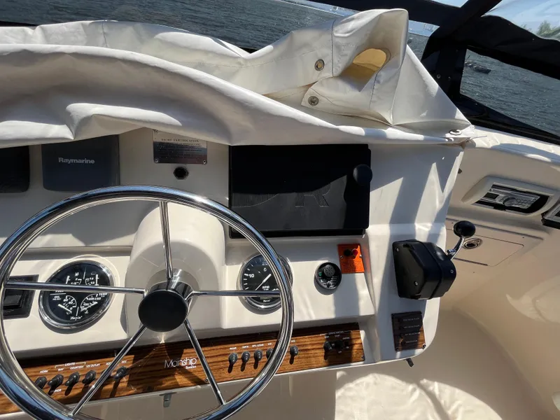 Slide: The Image of 2005 Mainship 400 Trawler helm with steering wheel, gauges, and navigation equipment. - 31