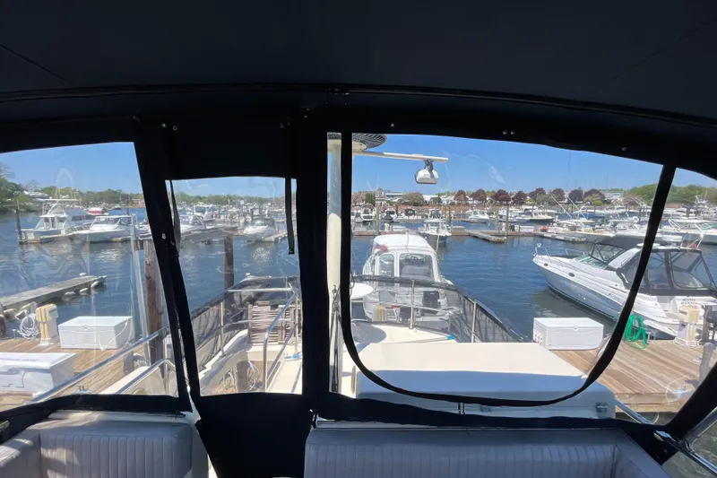 Slide: The Image of View from 2005 Mainship 400 Trawler cockpit overlooking marina with multiple boats docked. - 37