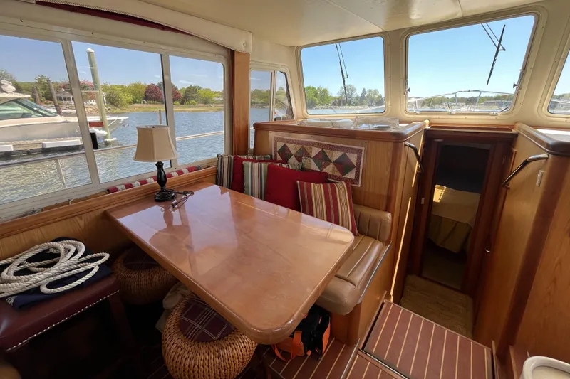 Slide: The Image of Interior of 2005 Mainship 400 Trawler with dining area and waterfront view. - 41