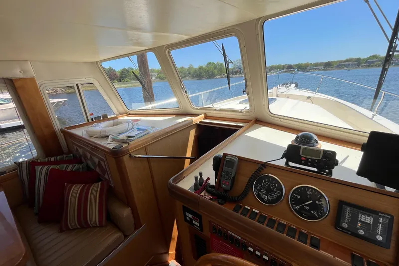 Slide: The Image of Interior view of 2005 Mainship 400 Trawler with helm, gauges, and seating area. - 44