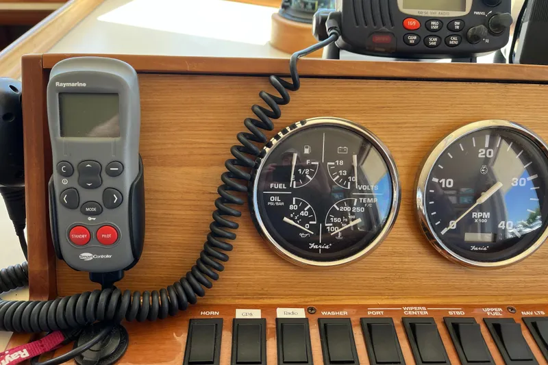 Slide: The Image of Control panel of a 2005 Mainship 400 Trawler with gauges and switches. - 45