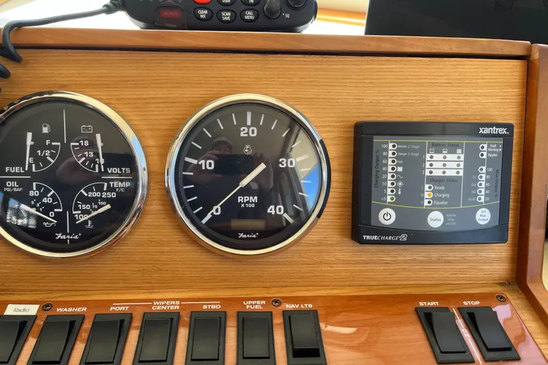 Slide: The Image of Control panel of a 2005 Mainship 400 Trawler with gauges and switches. - 46
